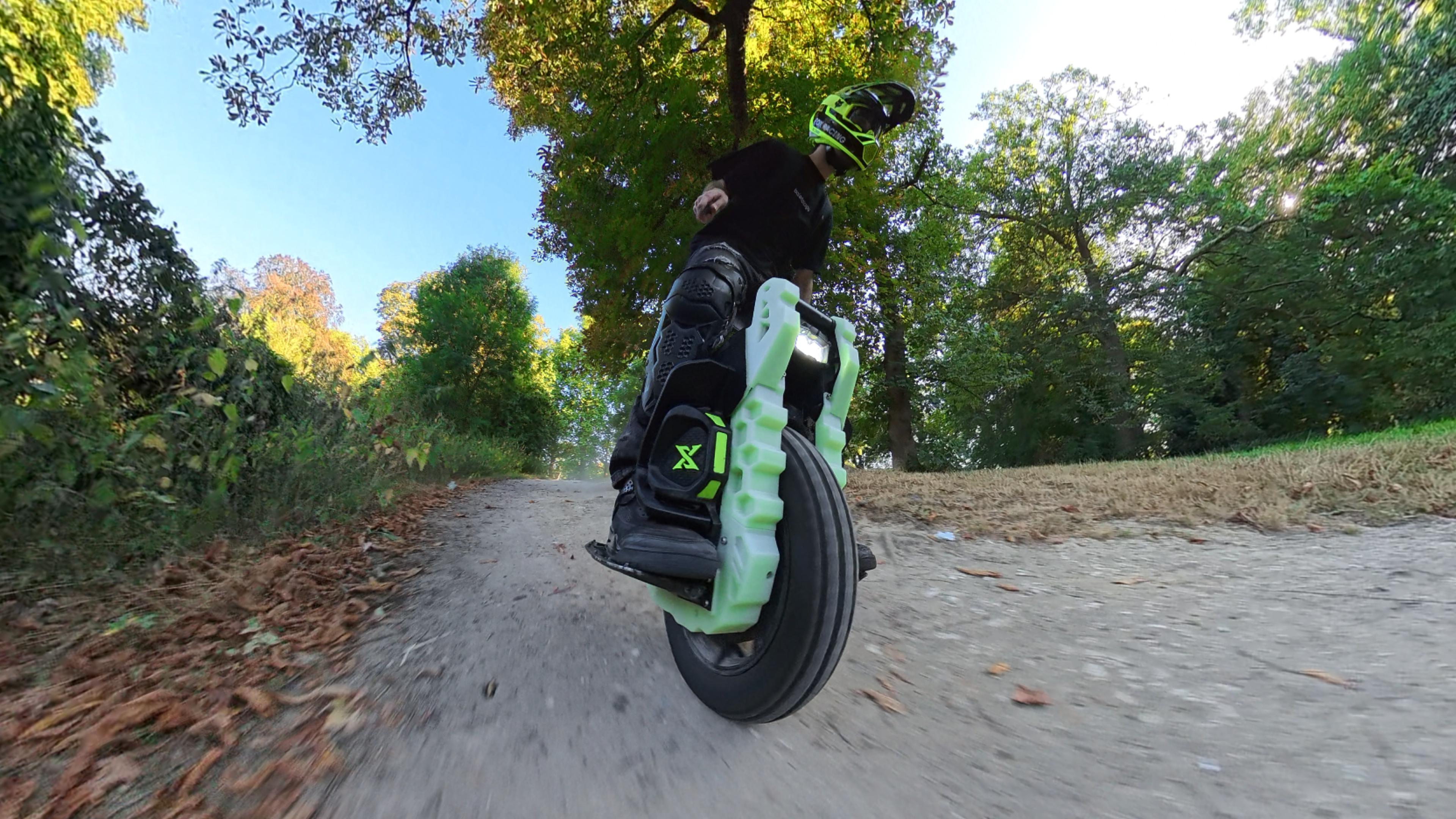Leaperkim Lynx OG fitted with the fluo green IXEZED armor kit, riding on a trail
